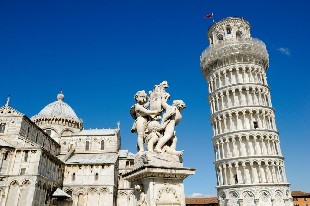 The Pisa Cathedral, The Fountain with Angels, and the Leaning Tower of Pisa in Piazza dei Miracoli in Pisa, Italy.