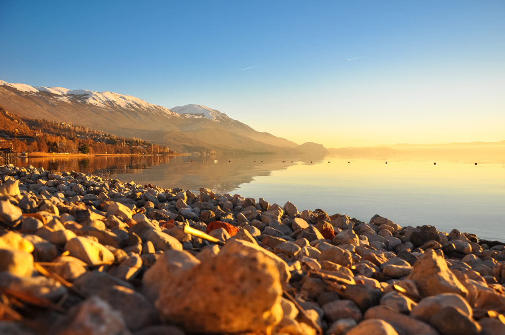 Susnet at the rocky beach at Ohrid Lake with view on the mountains