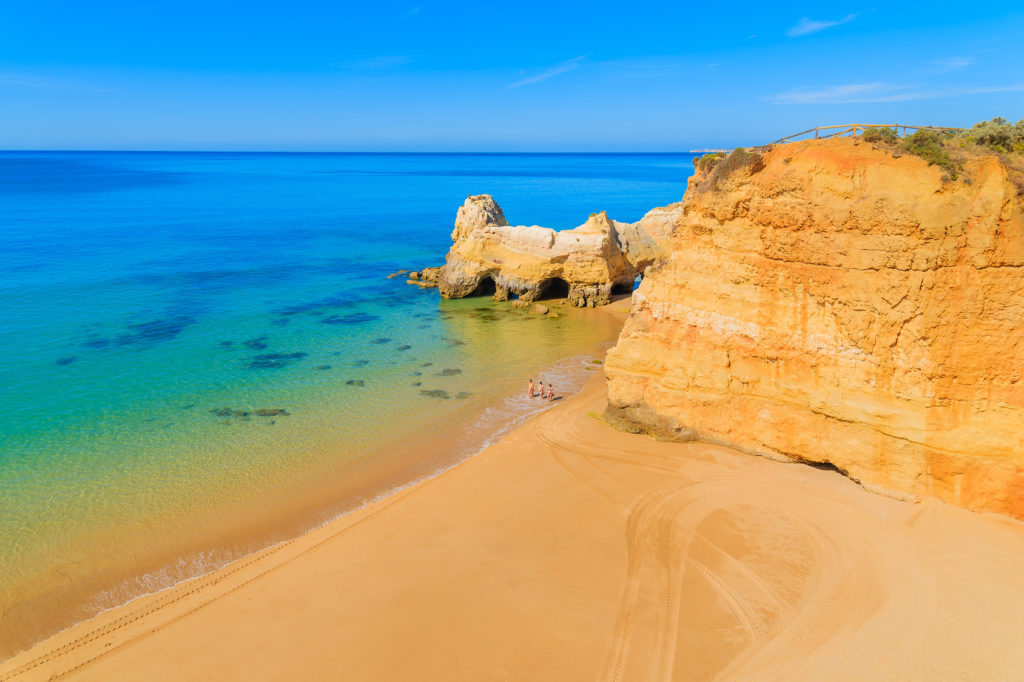 A view of a Praia da Rocha beach with golden cliff rocks in Portimao town, Algarve region, Portugal