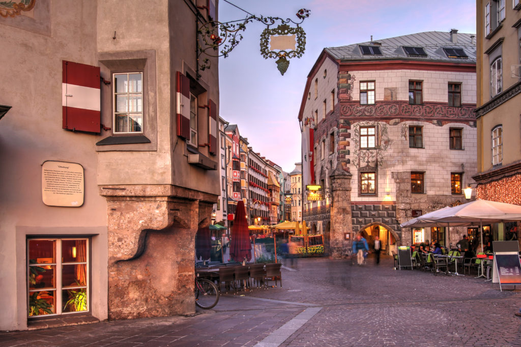 Evening scene in central Innsbruck, Austria. The scene is captured along the famous Herzog-Friedrich featuring some of the historical houses linining the street.