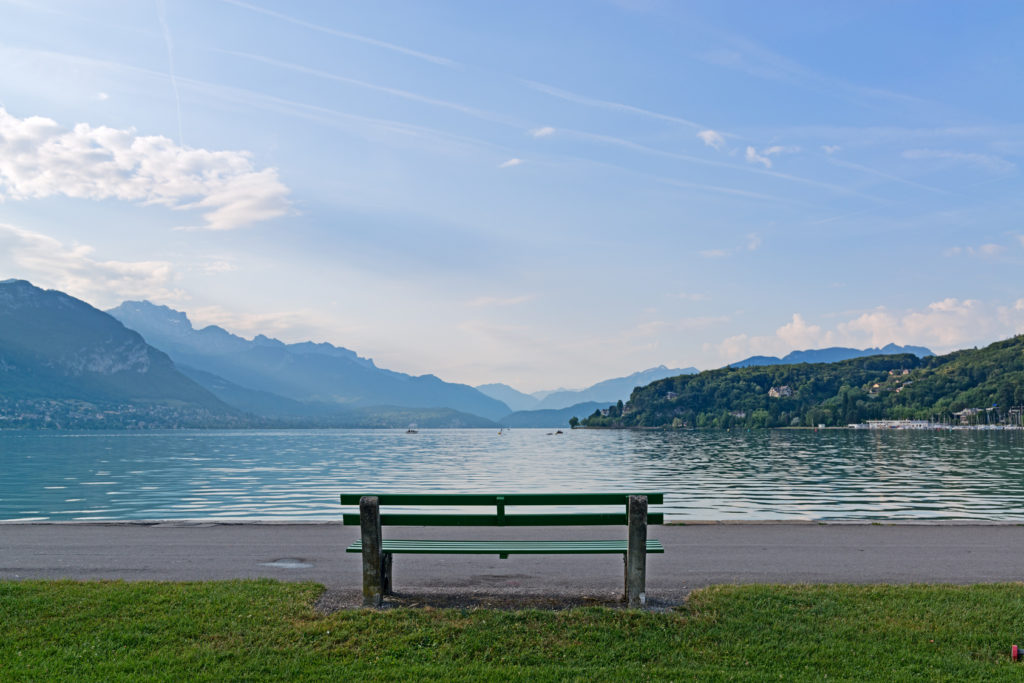 Beautiful lake and a bench with view on mountains