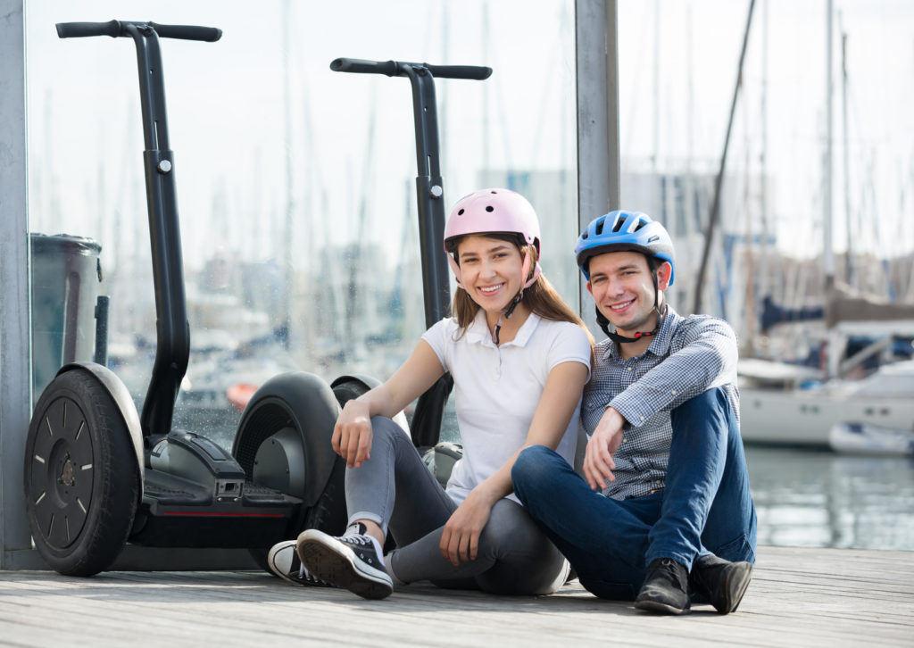 Man and woman with segways