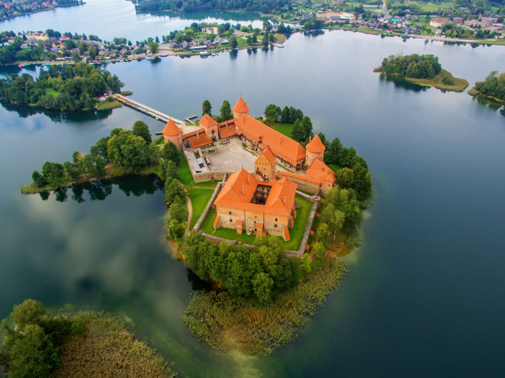 Trakai, Lithuania: aerial UAV top view of Island Castle in the sunrise. Historical residence in capital city of Grand Duchy of Lithuania, located in Galve lake