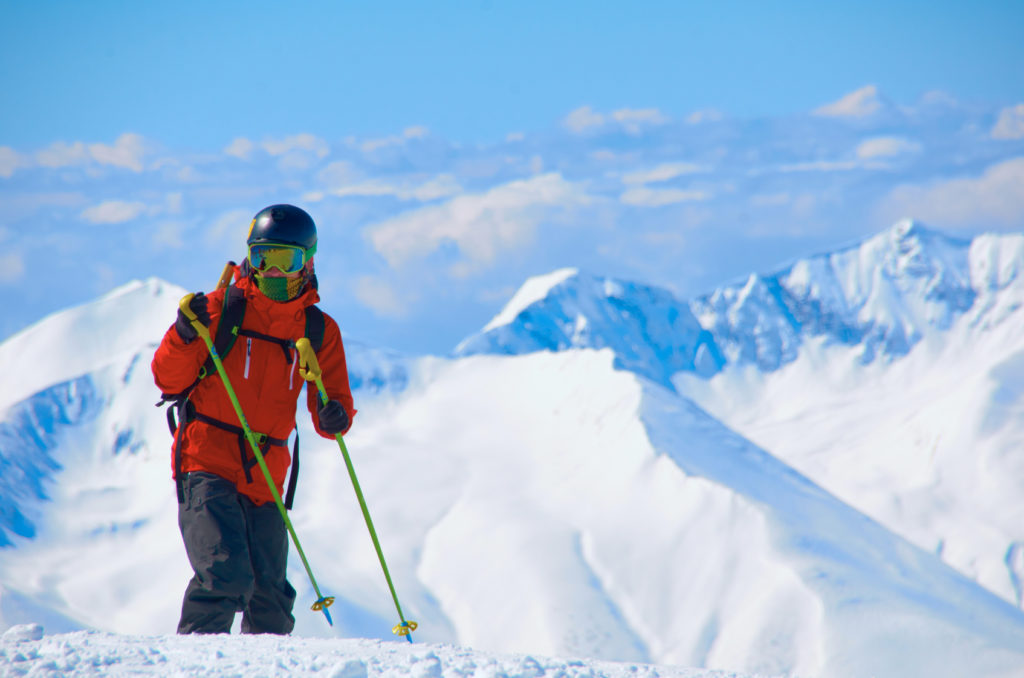 Winter sport cocept with mountain peak, snowboarders background. High point on the winter ski resort. Dangerous adventures.