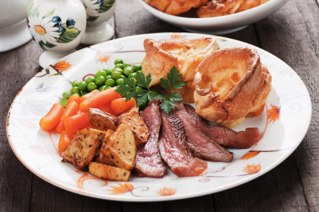Traditional british sunday roast with yorkshire pudding, roasted potato and vegetables